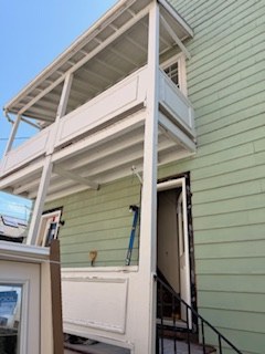 Before — porch and windows mid-renovation