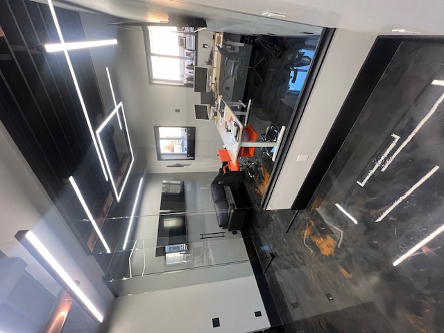High Pace office lounge with seating, a meeting table, and linear ceiling lights