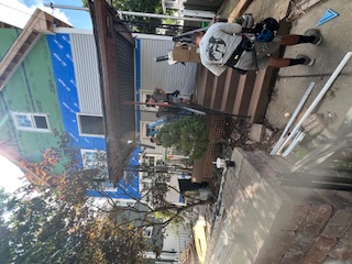 Crew working on siding and a covered porch