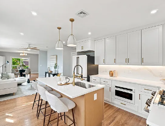 After — wide kitchen view with island and open-plan living area