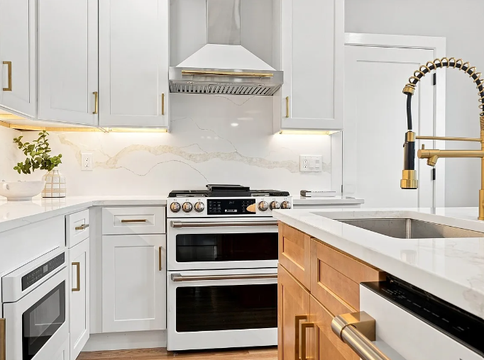 After — bright renovated kitchen with white cabinetry and wood island