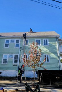 Before — exterior during re-siding and roof work