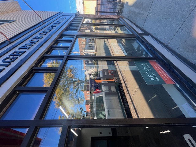 Angled view of the glass High Pace Construction storefront