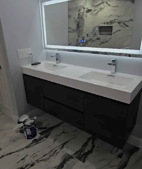 Bathroom with floating double vanity, LED mirror, and marble-look tile